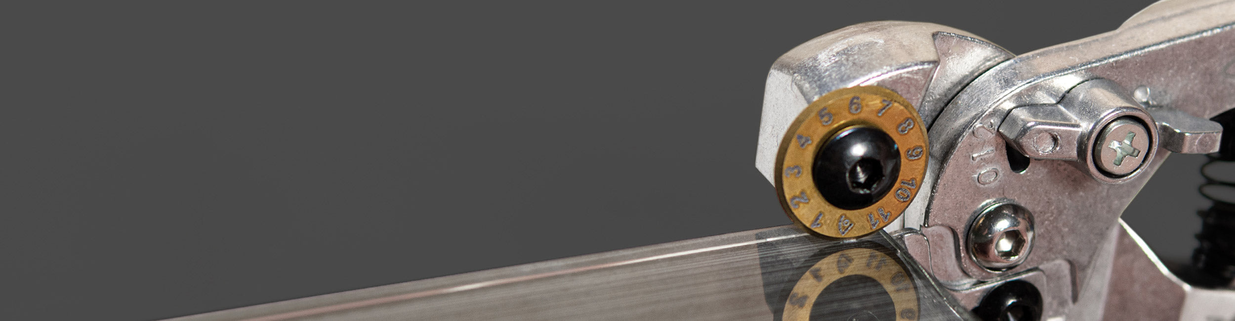 Close-up of an installer using a QEP Xtreme Pro Control Glass Tile Nipper to cut a glass tile