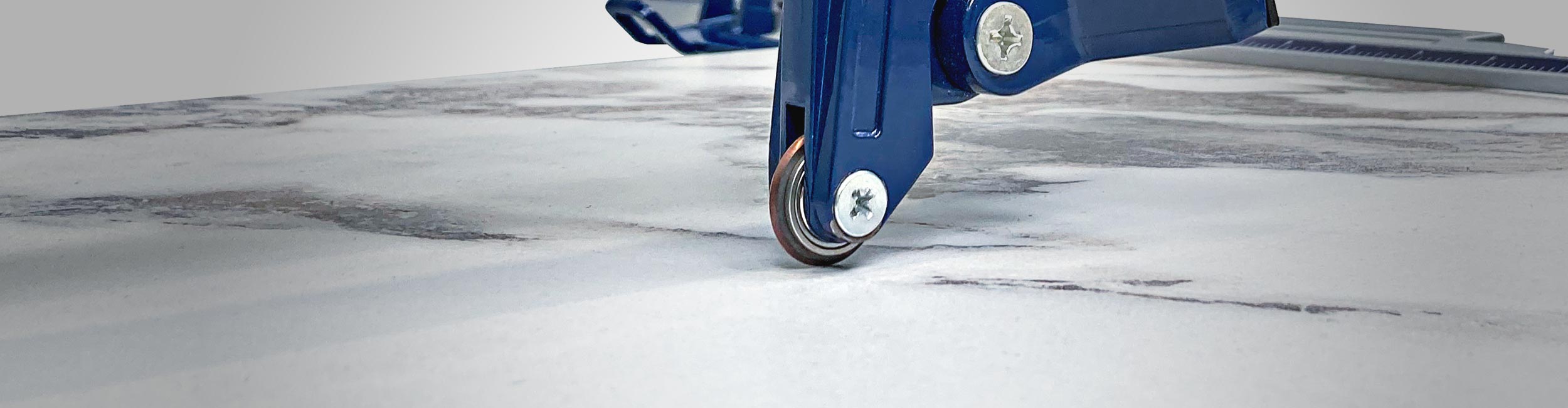 Close-up view of a QEP tile cutter's scoring wheel being used to score a tile