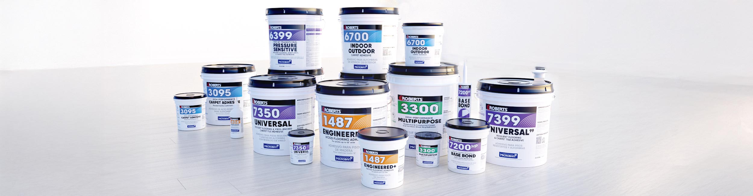 A variety of ROBERTS flooring adhesive buckets stacked together