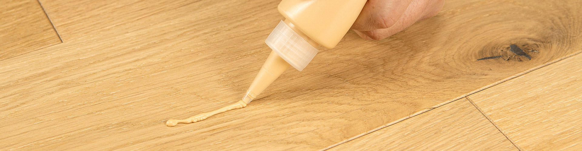 ROBERTS Palette Quick-Repair Putty being applied to a wood floor