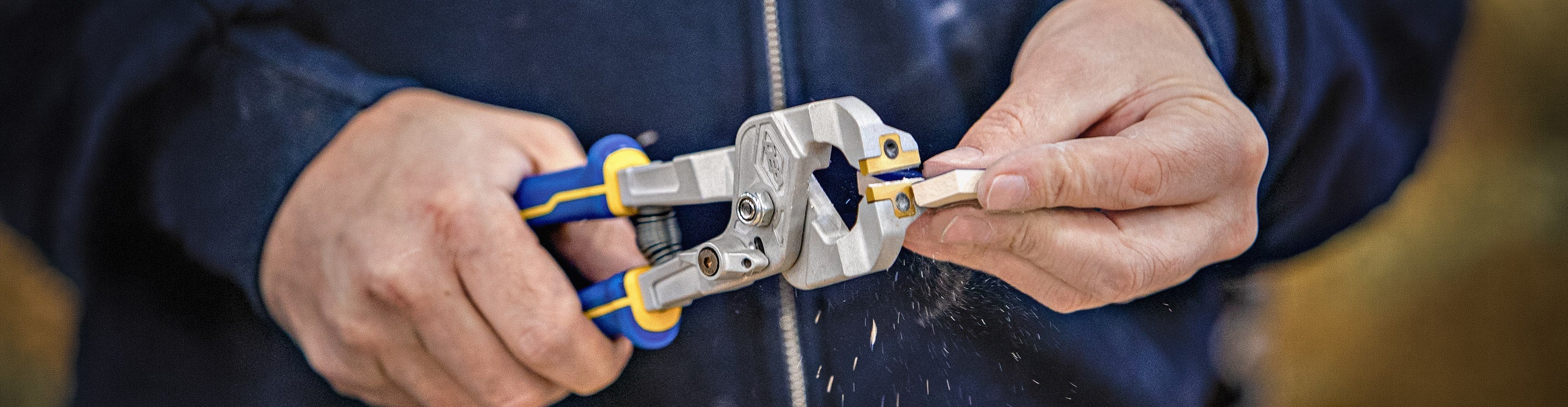 Close-up of QEP's Compound Tile Nipper making cuts on the corner of a piece of tile