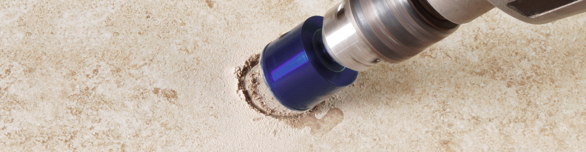 A QEP Xtreme wetDRY Diamond Hole Saw in-use, drilling a hole in tile