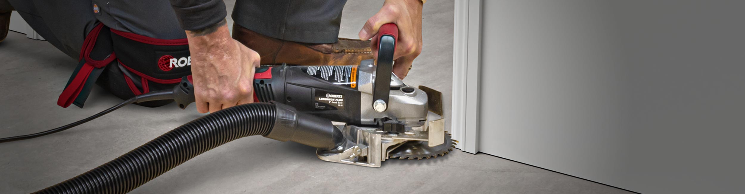 Close-up of installer using ROBERTS Longneck Plus 6in. Jamb Saw to cut a door jamb