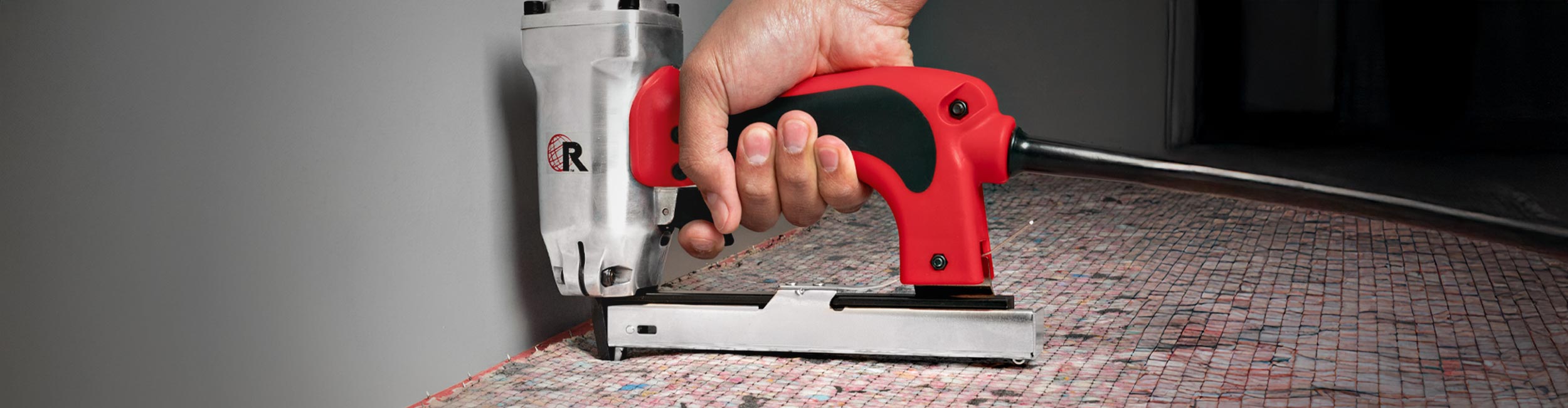 Installer using ROBERTS Professional Electric Stapler to tack down carpet padding