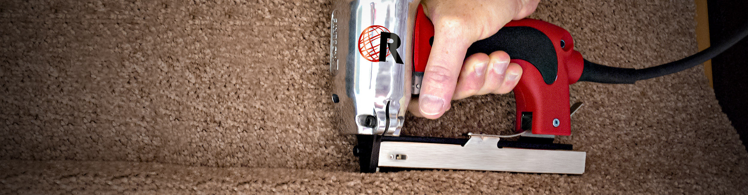 Close-up of a carpet installer using a ROBERTS Professional Electric Stapler to secure carpet to stairs