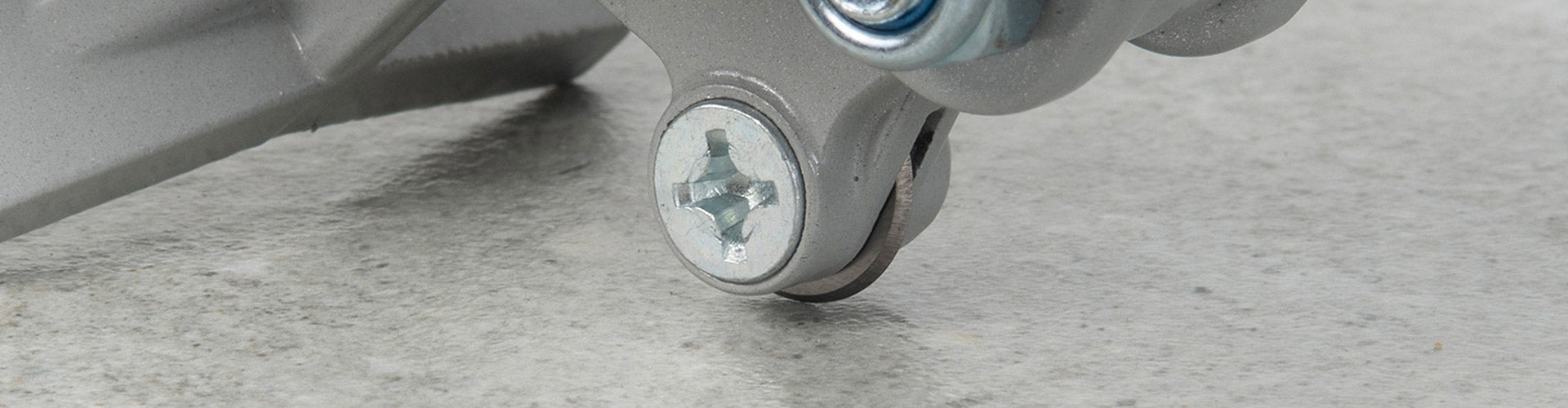 Close-up view of a QEP tile cutter's scoring wheel being used to score a tile