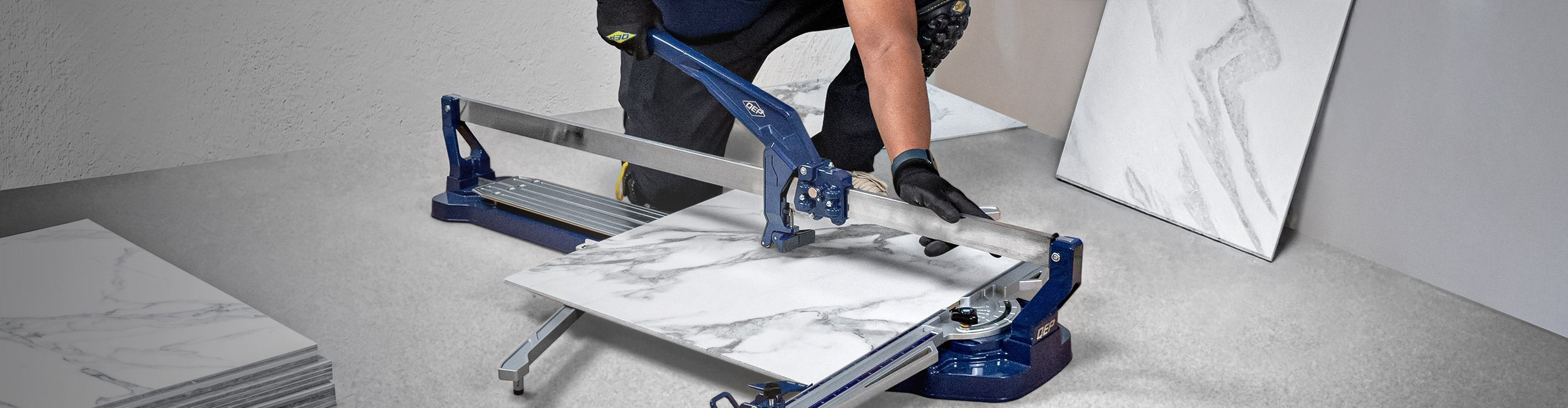 Close-up of installer using QEP's 25" Big Clinker Tile Cutter to cut porcelain tile