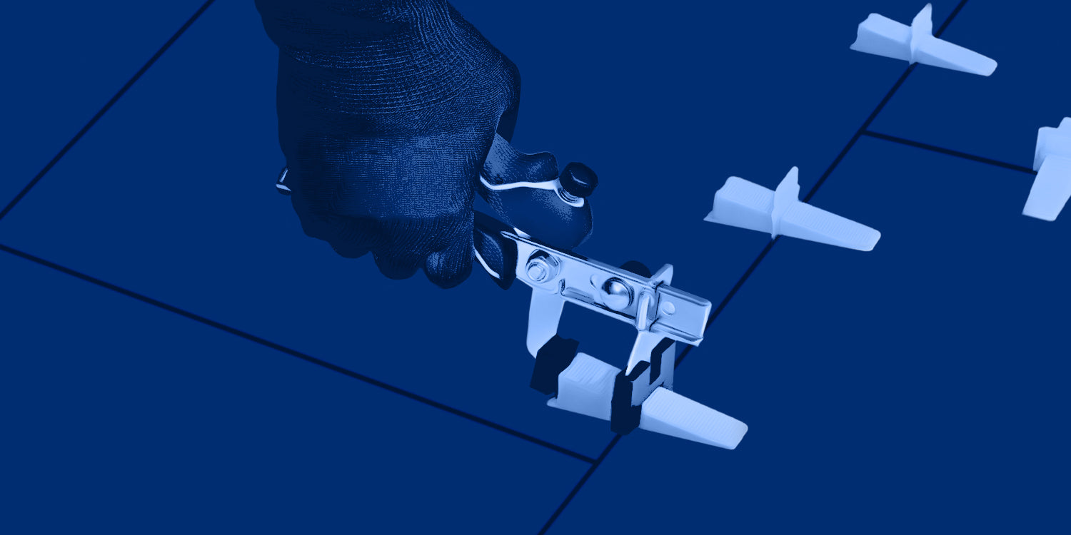 Installer wearing tiler's gloves while tightening QEP LASH Tile Leveling System with Pro Installation Pliers